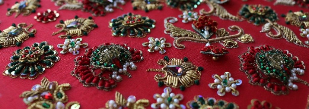 Gold zari and bead embroidery on red fabric